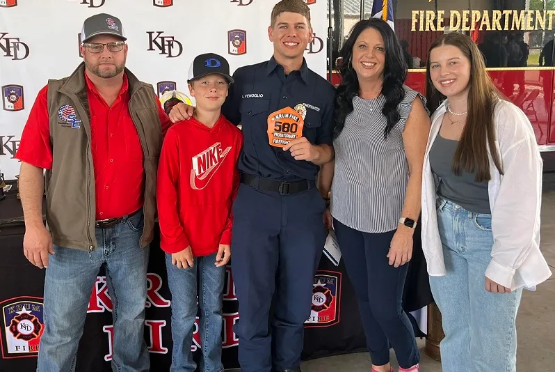 The Fenoglio family standing together at a fire department event