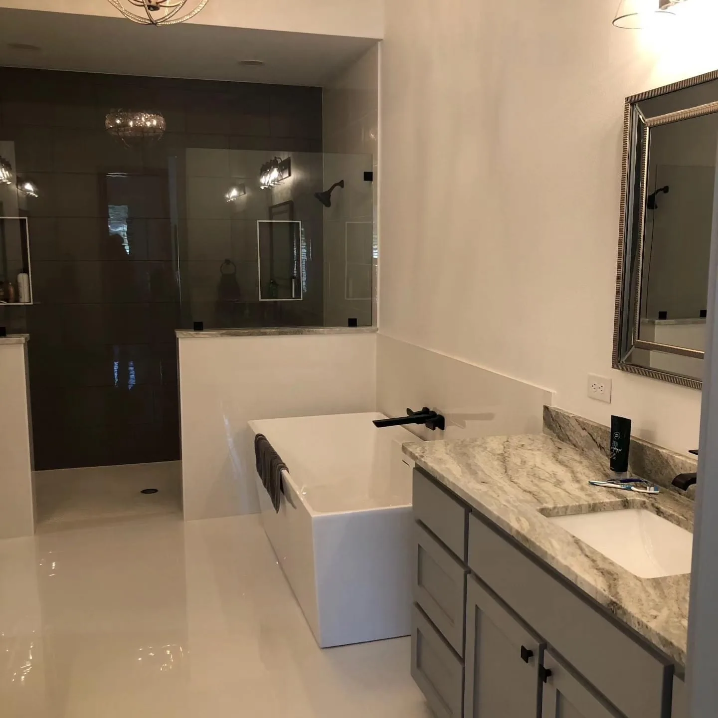 Primary bathroom with a freestanding tub and a glass-walled shower