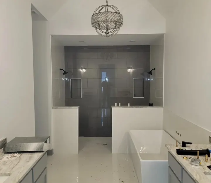 Bathroom with a tiled double walk-in shower and a freestanding tub